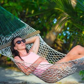 woman-in-swimsuit-relaxing-on-hammock-sunbathing-MM4AHT2.jpg